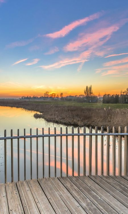 Wooden deck balustrade sunset over swamp